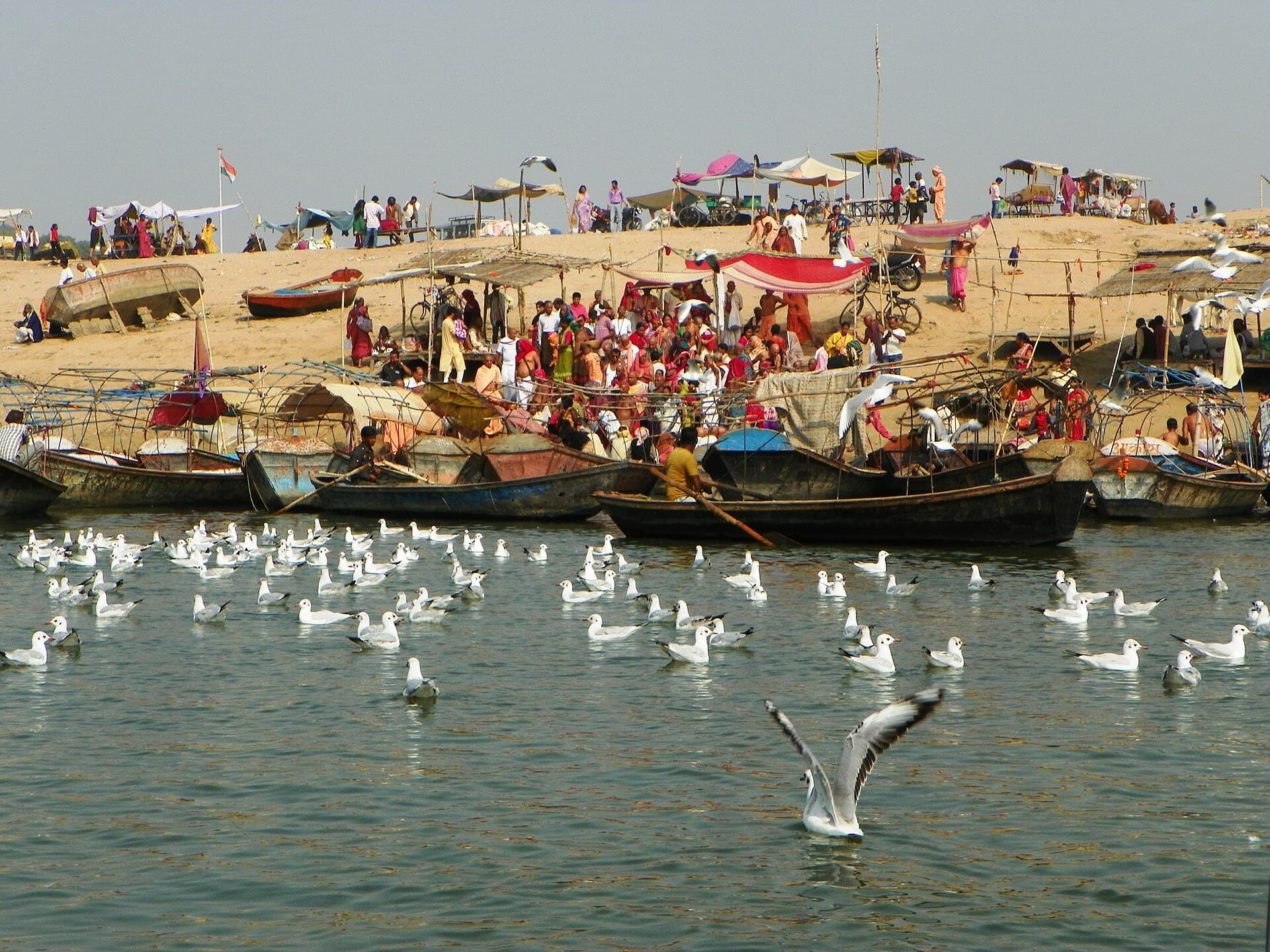 Boats and pilgrims at the Triveni Sangam in Prayag